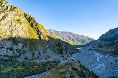 Scenic view of mountains against clear blue sky