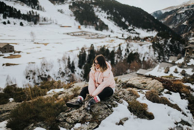 Woman sitting on rock