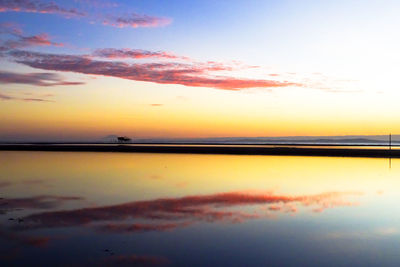 Scenic view of sea against romantic sky at sunset