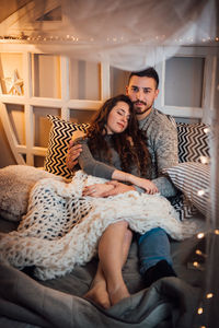 Young couple sitting on table at home