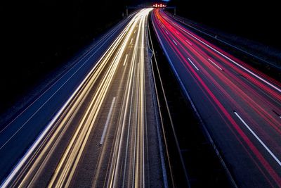 High angle view of light trails on highway at night
