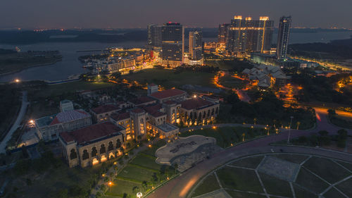 High angle view of illuminated buildings in city at night