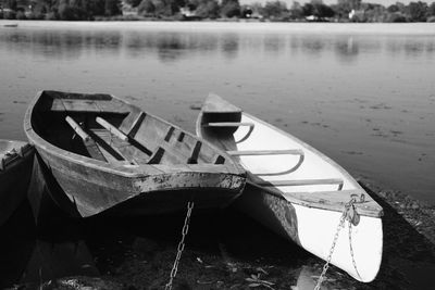 Reflection of boat moored in lake