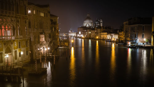 Canal passing through city at night