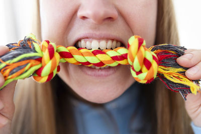 Midsection of woman holding rope