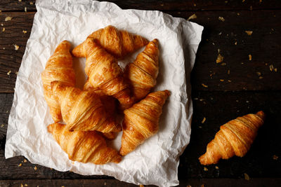 Freshly baked croissants on grey wooden table