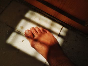 High angle view of hand on floor at home