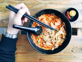 Person having laksa for breakfast