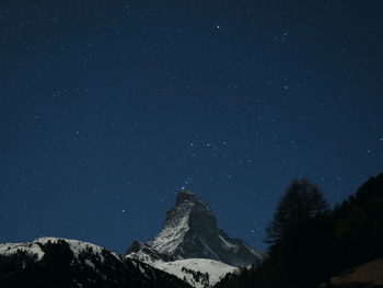 Scenic view of mountains against sky at night