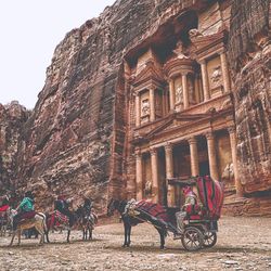 People sitting in front of historical building