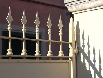 Close-up of white railing against building