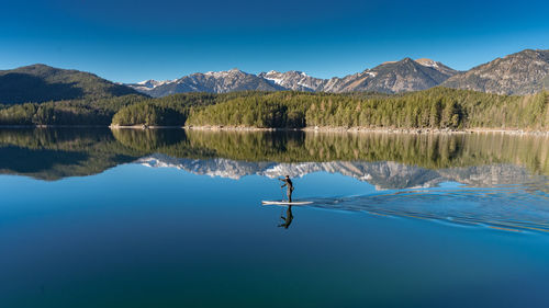 Person paddleboarding on lake