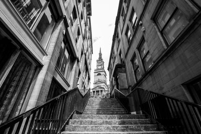 Low angle view of staircase amidst buildings in city