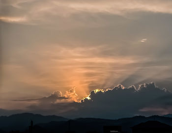 Low angle view of silhouette mountain against dramatic sky