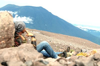 Man sitting on rock