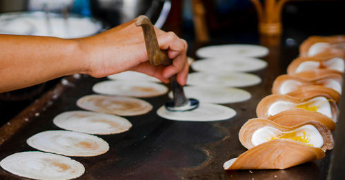 Cropped image of person preparing food