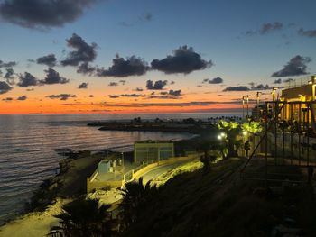 Scenic view of river against sky during sunset