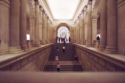 People walking in corridor of building