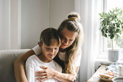 Mother and daughter sitting at home