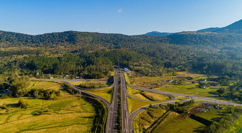 High angle view of road amidst trees against sky