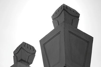 Low angle view of statue against building against clear sky