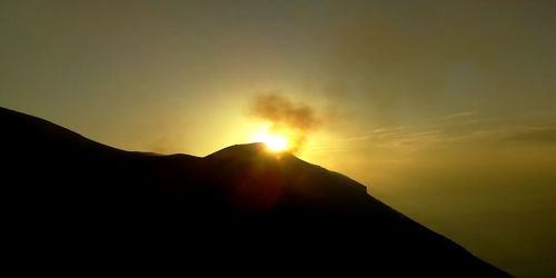 Scenic view of silhouette mountain against sky during sunset