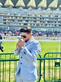 Side view of young man using mobile phone