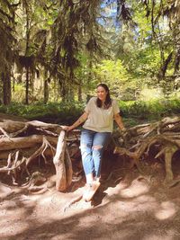 Full length of woman standing in forest