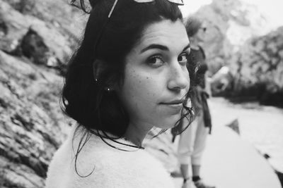 Close-up portrait of young woman looking away outdoors