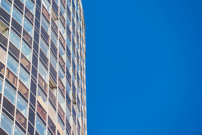 Low angle view of modern building against clear blue sky