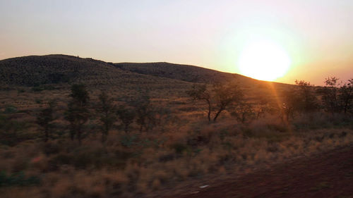 Scenic view of mountains against clear sky during sunset