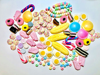 High angle view of multi colored toys on white background