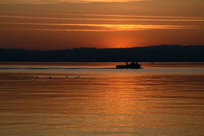 Scenic view of sea against orange sky