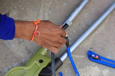 High angle view of man working on metal