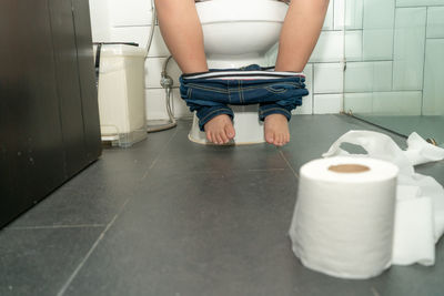 Low section of woman in bathroom