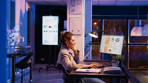 Young woman using laptop at table