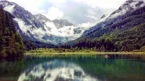 Scenic view of lake against cloudy sky