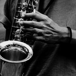 Midsection of man playing saxophone