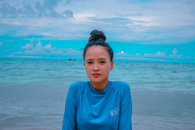 Portrait of a woman standing at the beach