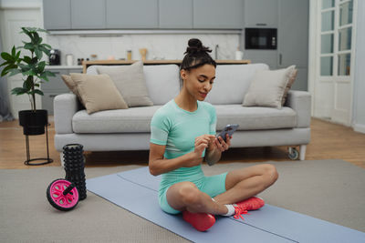 Portrait of woman sitting on sofa at home