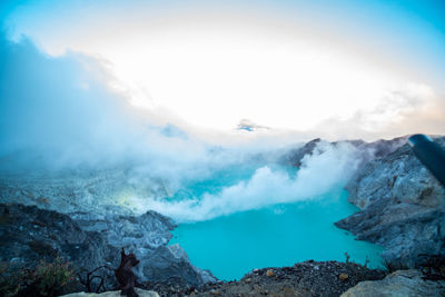 Smoke emitting from volcanic mountain against sky