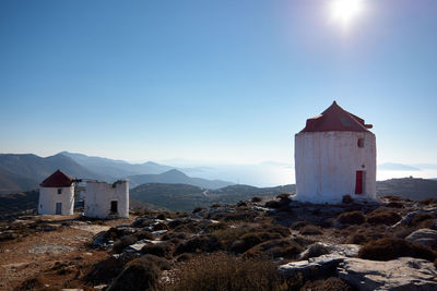 Buildings against mountains and sky