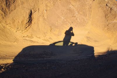 Shadow of woman on sand