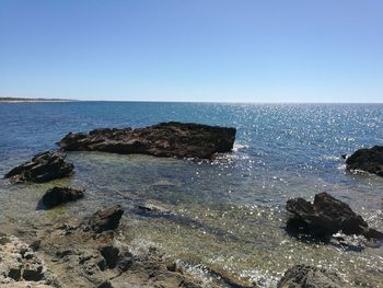 Scenic view of sea against clear blue sky