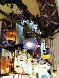 Low angle view of illuminated lanterns hanging on ceiling