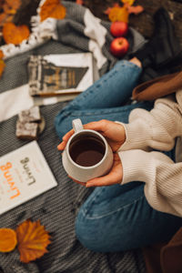 High angle view of hand holding coffee cup