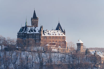 Building against sky during winter