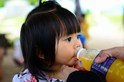 Close-up portrait of a girl drinking glass