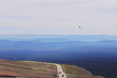 Scenic view of sea and mountains against sky