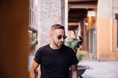 Young man wearing sunglasses standing outdoors